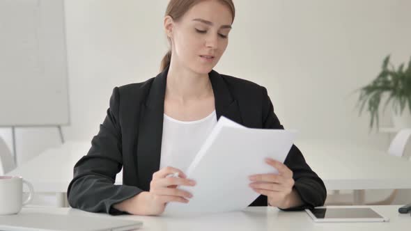 Young Businesswoman Reading Important Papers