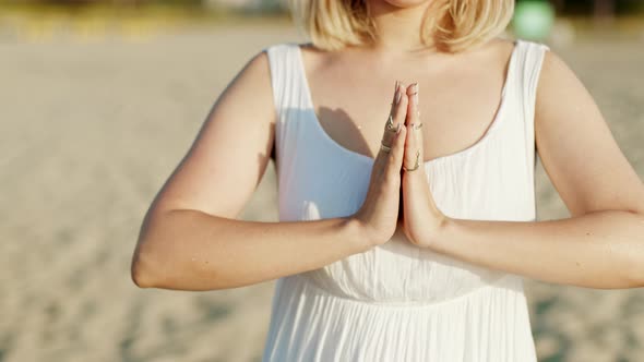 Woman Practicing Yoga, Namaste Gratitude Mudra Alone on Sand Beach at Summer Sunset Time. Girl in