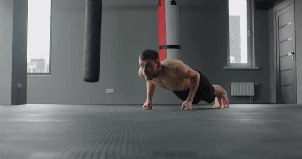 Athlete Performs Fast Pushups on His Fists at the Gym Camera Follows the Movement Workout Training