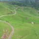 Top view of the mountain road through the green field. - VideoHive Item for Sale