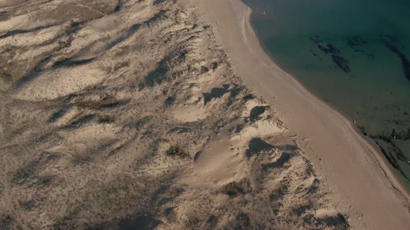 Video over beautiful wild beach with sand dunes and clear waters