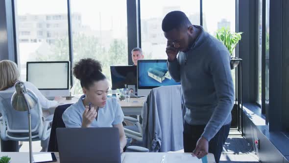 Young man and woman working on computer