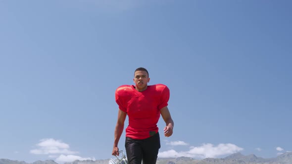 American football player walking with helmet