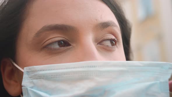 Closeup Portrait of Woman Putting Medical Mask on Her Face While Quarantining Virus Coronavirus