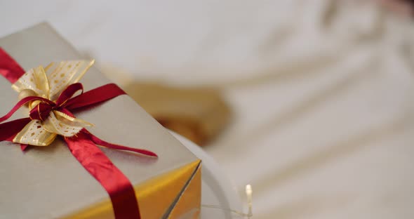 Closeup Of Christmas Gift Box Tied With Ribbon
