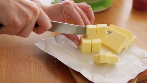 Hands Cutting Butter and Putting on Scale