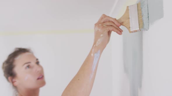 Portrait of a Caucasian woman in quarantine during coronavirus pandemic, doing interior work