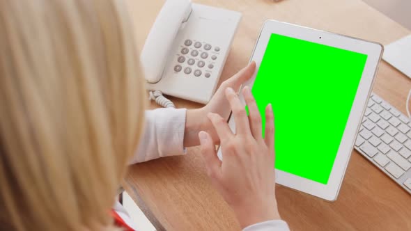 Businesswoman using digital tablet at her desk