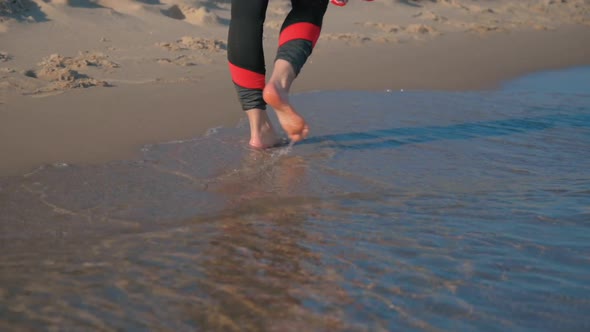 Barefoot Woman Legs on Sand