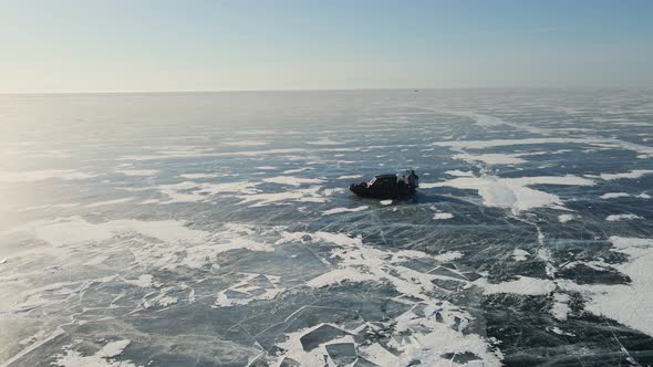 Hovercraft Gliding on Beautiful Frozen Ice Surface of Baikal Lake in Winter in Russia