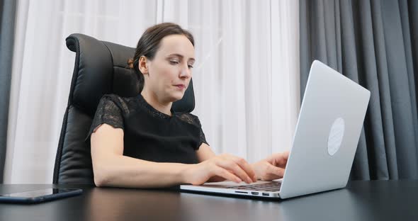 Young woman working on laptop and typing on keyboard, Business concept