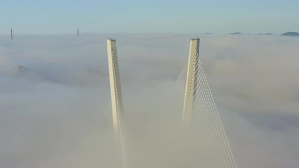 Tops of the Pylons of the Golden Bridge in the Dawn Fog in Vladivostok