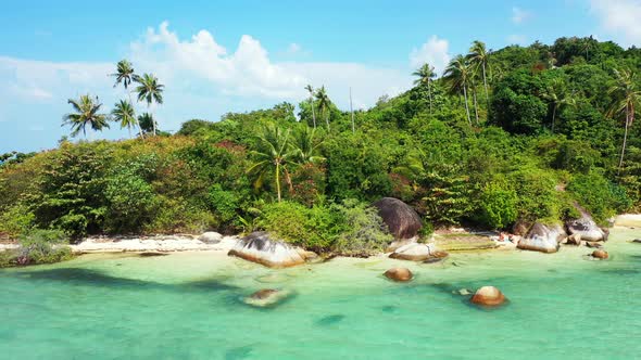 Wide overhead abstract shot of a white paradise beach and turquoise sea background in 4K