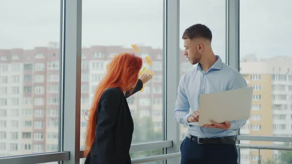 Caucasian Woman and Man Working in the Office. Female Manager Communicates with Businessman Working