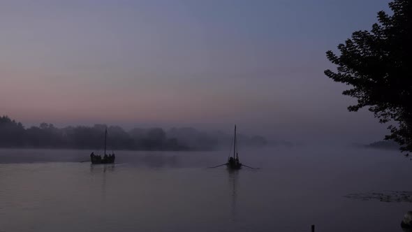 Old boats at foggy dawn on the water