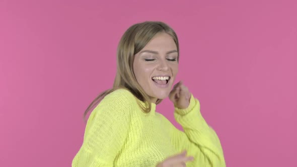 Excited Young Girl Dancing and Celebrating Pink Background