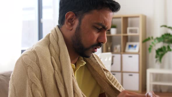 Sick Man Measuring Temperature By Thermometer