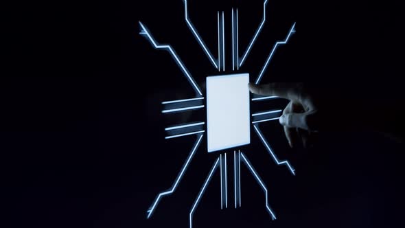 Human finger is pressing a digital button on a glowing touchscreen.