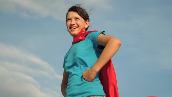 Beautiful Girl Superhero Standing on Field in Red Cloak