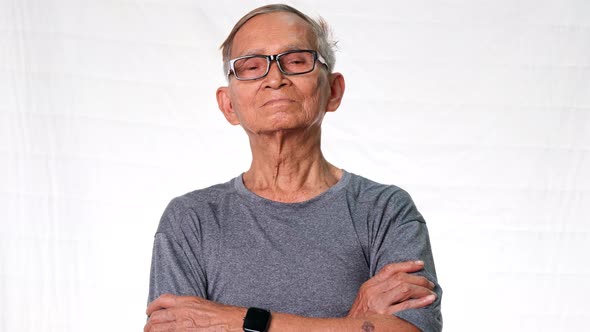 Serious senior man over a white studio background