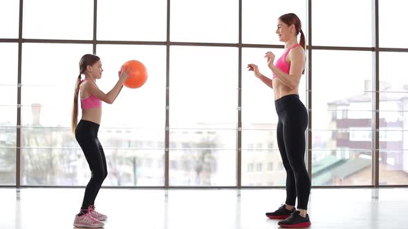 Fitness exercises, for children, a female trainer teaches in the gym