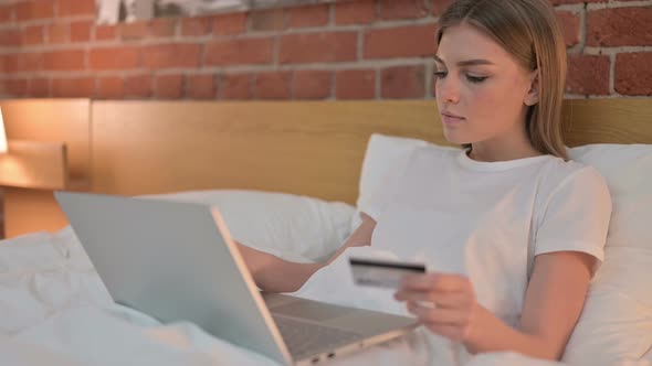 Young Female Celebrating Online Payment Success on Laptop