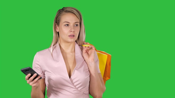 Shopping Woman Text Messaging on A Green Screen, Chroma Key