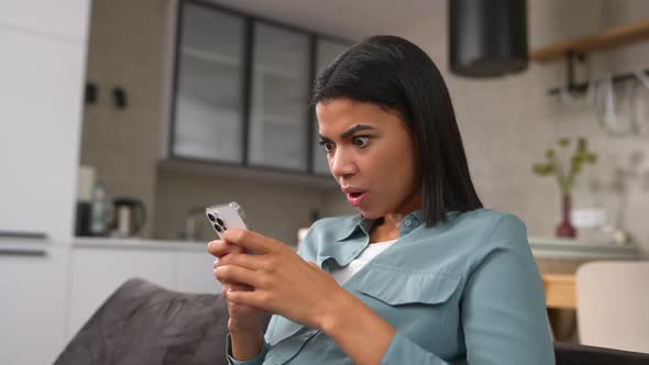 Overjoyed Woman Looking at Phone Screen Celebrating Success