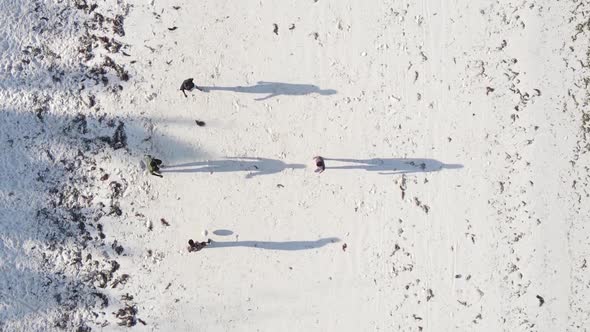 Vertical Video People Play Football on the Beach in Zanzibar Tanzania Aerial View