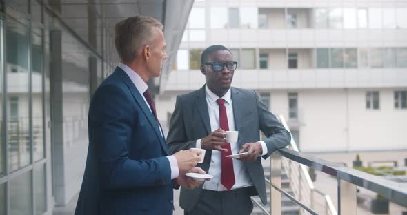 Diverse Employees Chatting Discussing Work During Coffee Break Outside Office