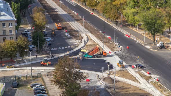 Asphalt Paver, Roller and Truck on the Road Repair Site During Asphalting Timelapse. Road