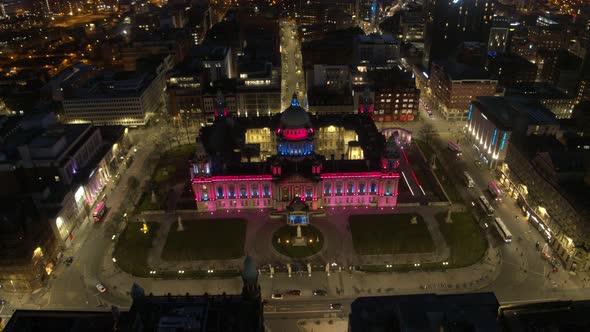 Aerial flyover of Belfast City Centre and Lagan River at night