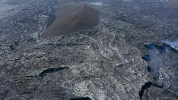 Vast Black Volcanic Lava Fagradalsfjall Landscape with Helicopter in Distance Over Hill