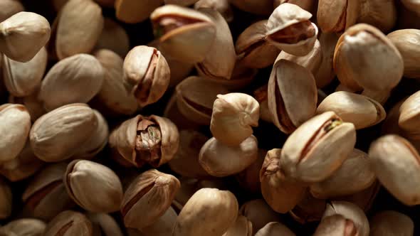 Super Slow Motion Shot of Pistachios Flies After Being Exploded Against Black Background, 1000Fps.