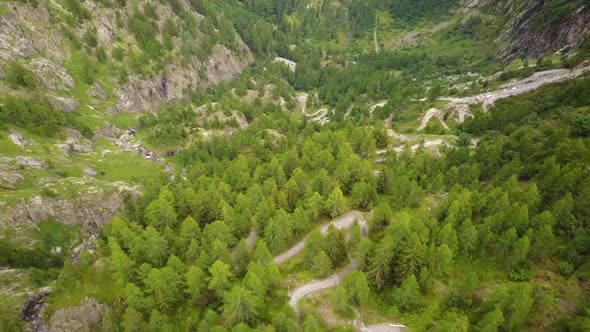 Natural trail in the swiss alps. aerial drone shot . fir trees forest