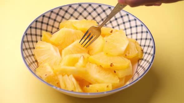 Slice of Pineapple in Bowl on Yellow Background