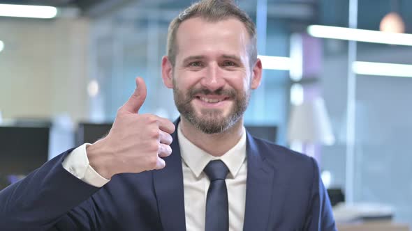 Portrait of Cheerful Young Businessman Showing Thumbs Up