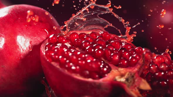 Slow Motion Shot of Pomegranate Juice Splashing Through Pomegranate