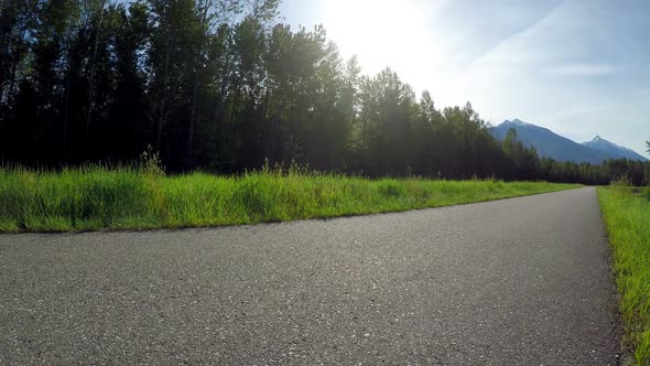 Woman riding unicycle on road