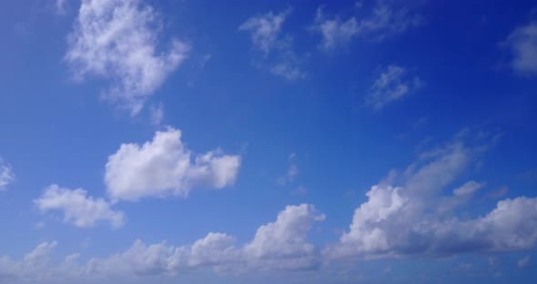 Wide birds eye abstract shot of a white paradise beach and blue sea background in colorful 4K