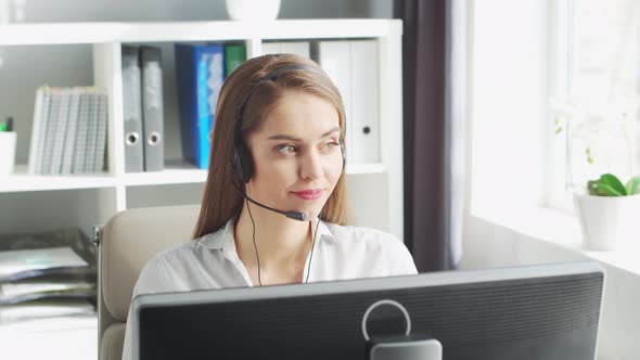 Young Woman Works at Home Office Using Computer.