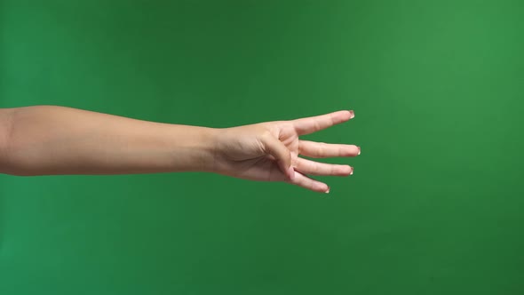 Woman Hand Show Four Fingers On Green Screen Background