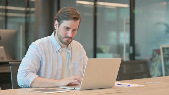 Mature Adult Man with Laptop Having Loss Failure