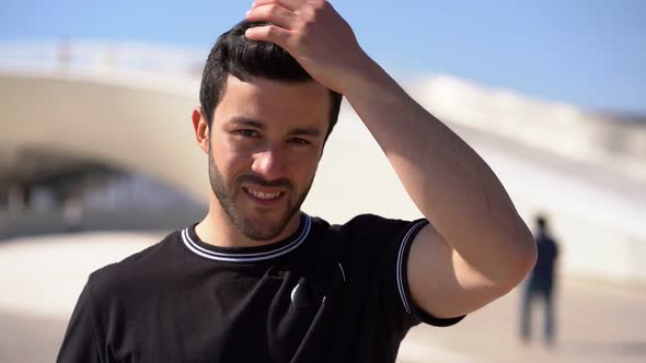 Handsome Happy Young Man Touching Hair Outdoor