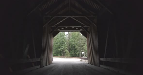 Pushing slowly forward towards the road through the dark, dramatic tunnel of the public Lowe's cover