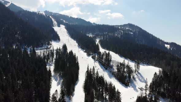 Aerial view of the ski slope at Poiana Brasov covered with snow