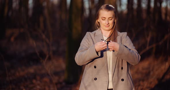 Beautiful Positive Female Wearing Sunglasses in Woods