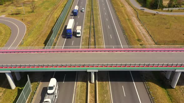 Traffic of cars and trucks on the Freeway in Summer day - top view shot. Top View shot of multi-lane