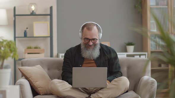 Cheerful Old Man Enjoying Music