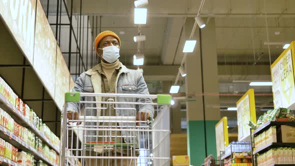 Black Man Shopper in Blue Denim Jacket and Face Mask